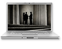 Laptop screen showing silhouettes of 3 people discussing outside a courthouse.